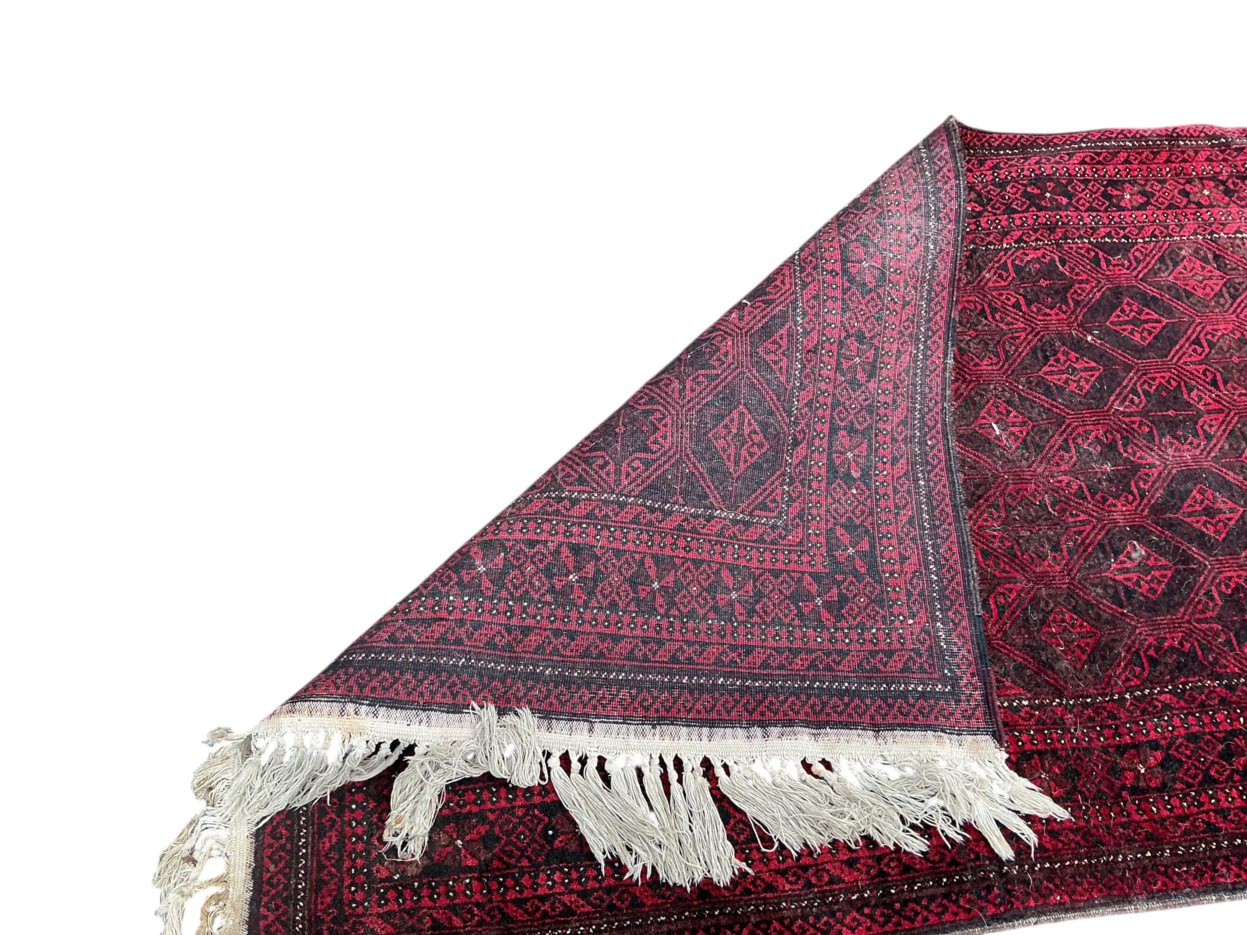A Belouch red ground rug and an Afghan rug, 180 x 100cm and 155 x 105cm
